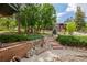 Beautifully landscaped front yard with stone walkway and brick retaining wall at 19 Rock Ln, Castle Rock, CO 80104