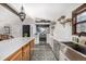 Bright kitchen boasts white cabinets, stainless steel appliances, quartz countertops, and an island for added workspace at 19 Rock Ln, Castle Rock, CO 80104