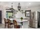 Open kitchen with stainless steel appliances, an island with bar seating, and unique decorative lighting above the island at 19 Rock Ln, Castle Rock, CO 80104