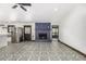 An open-concept living area includes a blue brick fireplace and a stainless steel refrigerator, creating a modern space at 19 Rock Ln, Castle Rock, CO 80104