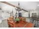 Open living area with kitchen, dining room table, and beamed ceiling at 19 Rock Ln, Castle Rock, CO 80104