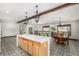 Open living area features an island with bar seating, dining room set, and a distinctive patterned tile floor at 19 Rock Ln, Castle Rock, CO 80104