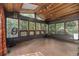 Spacious sunroom featuring a wood ceiling, tiled floor, large windows, and natural light at 19 Rock Ln, Castle Rock, CO 80104
