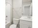 Bright bathroom features a toilet, tub, and a single sink vanity with white cabinets at 6541 N Malaya St, Aurora, CO 80019