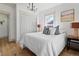 Comfortable bedroom boasts neutral decor and hardwood floors, perfect for relaxation at 5612 Ammons St, Arvada, CO 80002