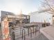 Exterior patio view of brewery with metal chairs and tables, stone ground, and black and grey facade at 5612 Ammons St, Arvada, CO 80002