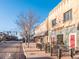 The Arvada Tavern with a brick facade and glass block entrance on a sunny day with blue sky at 5612 Ammons St, Arvada, CO 80002