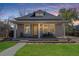 Charming home with a welcoming front porch and manicured lawn, perfect for relaxing evenings at 5612 Ammons St, Arvada, CO 80002