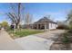 Charming home with a welcoming front porch and well-maintained lawn at 5612 Ammons St, Arvada, CO 80002