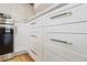 Bright kitchen features white cabinetry with sleek, modern hardware and stainless steel appliances at 5612 Ammons St, Arvada, CO 80002