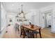 Open-concept kitchen featuring a center island with stool seating, a wooden dining table, and stainless steel appliances at 5612 Ammons St, Arvada, CO 80002