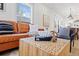 Bright living room showcases a leather couch and a view into the kitchen at 5612 Ammons St, Arvada, CO 80002