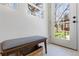 Welcoming mud room with bench seating and a view to the lush, private backyard at 5612 Ammons St, Arvada, CO 80002