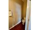 A small bathroom, complete with a toilet, tan walls, and hardwood flooring at 19246 E Idaho Pl # 102, Aurora, CO 80017