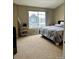 Bedroom with a large window, carpet, a bed, and a small storage unit at 19246 E Idaho Pl # 102, Aurora, CO 80017
