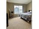 Cozy bedroom with neutral carpet, large window, and a comfortable bed at 19246 E Idaho Pl # 102, Aurora, CO 80017