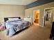 Cozy bedroom featuring neutral walls, carpet, and a bed with a blue and white comforter at 19246 E Idaho Pl # 102, Aurora, CO 80017