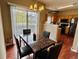 Cozy dining area features a marble table, modern chandelier, and a sliding glass door at 19246 E Idaho Pl # 102, Aurora, CO 80017