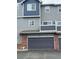 Exterior view of a townhome with a garage and brick facade at 19246 E Idaho Pl # 102, Aurora, CO 80017