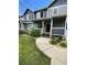 Inviting townhome featuring a charming front porch, landscaped yard, and two-tone gray and blue color scheme at 19246 E Idaho Pl # 102, Aurora, CO 80017