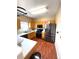 Well-lit kitchen featuring stainless steel appliances, wooden cabinets, and modern countertops at 19246 E Idaho Pl # 102, Aurora, CO 80017