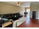 Spacious living room featuring a plush sectional sofa, hardwood floors, and a neutral color palette at 19246 E Idaho Pl # 102, Aurora, CO 80017