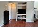 Open-concept living room with built-in shelves, media center, and hardwood floors at 19246 E Idaho Pl # 102, Aurora, CO 80017