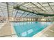 Spacious indoor pool with clear blue water and a bright, sunlit enclosure, providing a resort-like experience at 19246 E Idaho Pl # 102, Aurora, CO 80017