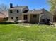 Large, grassy backyard with an elevated deck and covered patio area at 15962 E Exposition Dr, Aurora, CO 80017