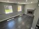 Finished basement with a cozy fireplace and large windows for natural light at 15962 E Exposition Dr, Aurora, CO 80017
