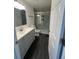 Bathroom with new vanity, toilet and glass enclosed shower with dark hardwood floors at 15962 E Exposition Dr, Aurora, CO 80017