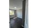 Bedroom with hardwood floors, grey walls and natural light from the window at 15962 E Exposition Dr, Aurora, CO 80017