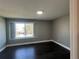 Bright bedroom features hardwood floors, neutral walls and a large window at 15962 E Exposition Dr, Aurora, CO 80017