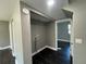 A laundry room featuring new dark floors and neutral colored walls at 15962 E Exposition Dr, Aurora, CO 80017