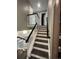 A staircase with dark wood stairs and white risers, leads to the upper level at 15962 E Exposition Dr, Aurora, CO 80017