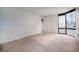 Bright, carpeted bedroom with a large window allows for downtown views at 1625 Larimer St # 605, Denver, CO 80202