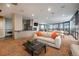 Open-concept living room with fireplace, modern furnishings, and access to outdoor seating at 1625 Larimer St # 605, Denver, CO 80202