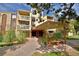 Exterior shot of building with multiple stories and front entrance, landscaping with green plants, and multiple balconies at 1300 S Parker Rd # 9, Denver, CO 80231