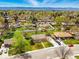 Neighborhood aerial view shows home in a verdant, tree-filled area with mountain views in the distance at 7751 S Race St, Centennial, CO 80122