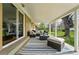 Covered back porch featuring comfortable seating, an outdoor rug, and access to the home's interior at 7751 S Race St, Centennial, CO 80122