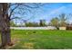 Private backyard features a cozy fire pit area, white fence, and mature trees for shade at 7751 S Race St, Centennial, CO 80122
