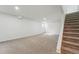 Unfinished basement space featuring carpeted floors and stairs at 7751 S Race St, Centennial, CO 80122