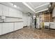 Utility area with cabinets, laundry sink, water heater, and other mechanicals at 7751 S Race St, Centennial, CO 80122