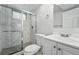 Bathroom featuring a glass-enclosed shower with marble-style tile and a modern vanity at 7751 S Race St, Centennial, CO 80122