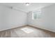 Well-lit bedroom with a window providing natural light and neutral-toned carpeting at 7751 S Race St, Centennial, CO 80122
