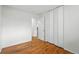 Empty bedroom featuring hardwood floors and a closet at 7751 S Race St, Centennial, CO 80122