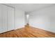 Empty bedroom featuring hardwood floors and a closet at 7751 S Race St, Centennial, CO 80122