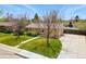 Charming single-story home with a well-maintained front yard, walkway, and mature trees under a bright blue sky at 7751 S Race St, Centennial, CO 80122