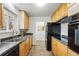 Functional kitchen featuring ample wood cabinetry and dark countertops at 7751 S Race St, Centennial, CO 80122