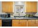 Functional kitchen featuring ample wood cabinetry and stainless steel sink at 7751 S Race St, Centennial, CO 80122